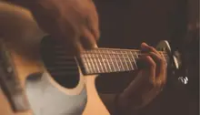Person som spelar på en gitarr